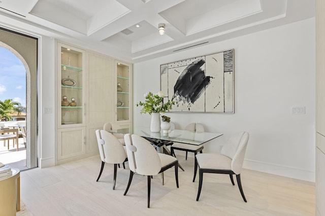 dining space with beamed ceiling and coffered ceiling