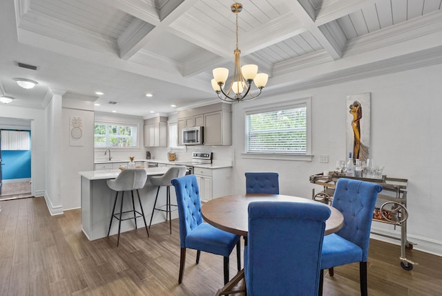 dining area with beam ceiling, dark hardwood / wood-style flooring, an inviting chandelier, and crown molding