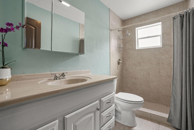 bathroom with a shower with shower curtain, tile patterned floors, vanity, and toilet