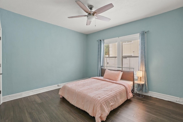 bedroom with ceiling fan and dark hardwood / wood-style flooring