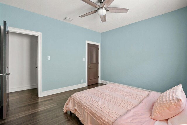 bedroom with ceiling fan and dark hardwood / wood-style floors