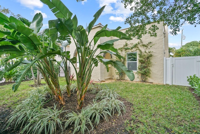 view of side of property with a lawn