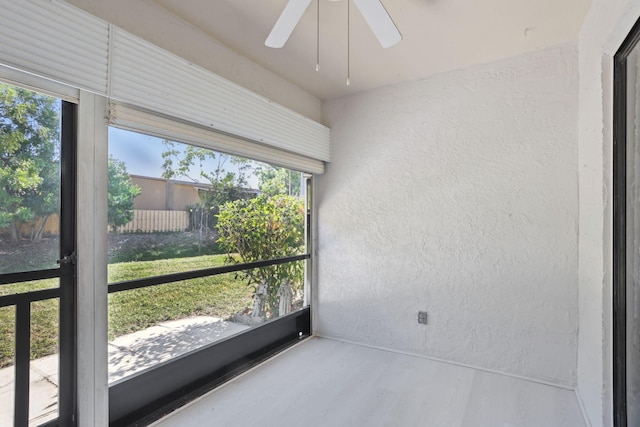 sunroom featuring ceiling fan