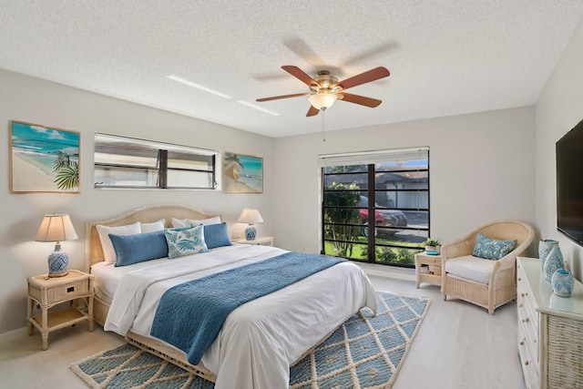 bedroom with ceiling fan and a textured ceiling