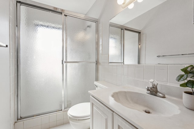 bathroom featuring vanity, toilet, walk in shower, and a wealth of natural light