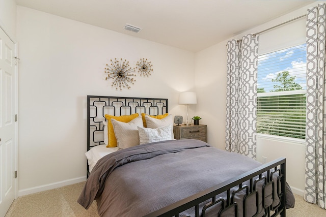 carpeted bedroom featuring visible vents and baseboards