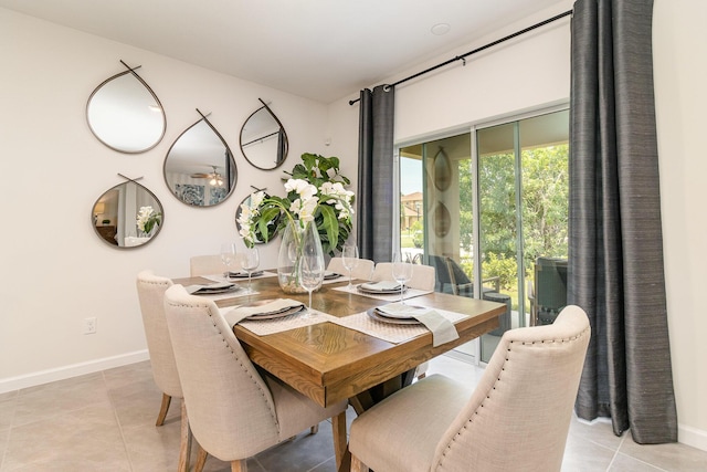 dining space with light tile patterned floors and baseboards