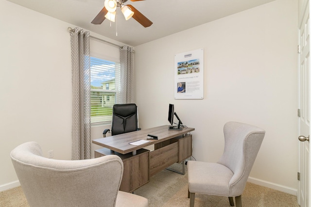 carpeted office featuring ceiling fan and baseboards