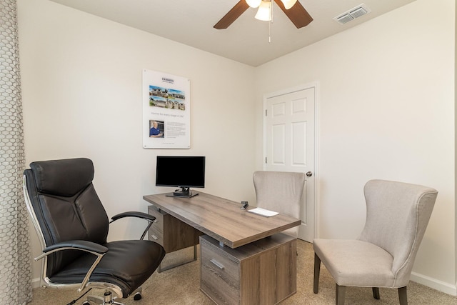 carpeted office space with visible vents, baseboards, and ceiling fan