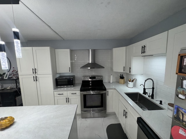 kitchen featuring white cabinetry, wall chimney exhaust hood, stainless steel appliances, and sink