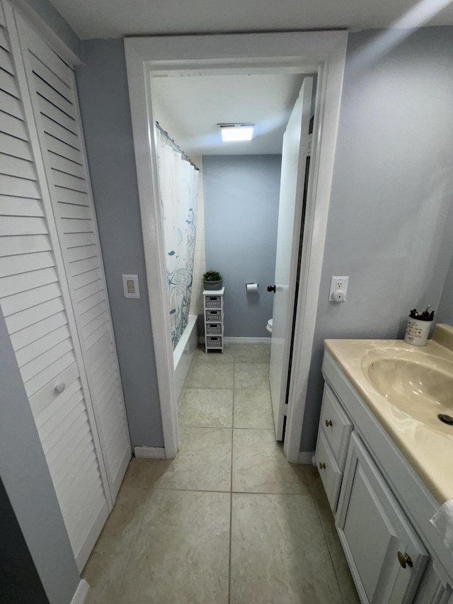 full bathroom with vanity, shower / bath combo, tile patterned floors, and toilet