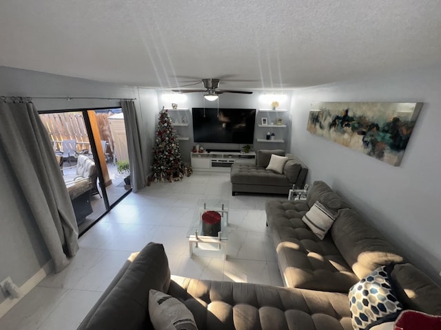 living room with ceiling fan and a textured ceiling