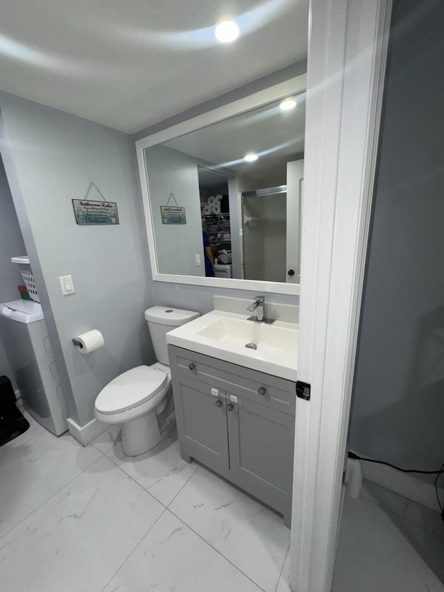 bathroom featuring vanity and toilet