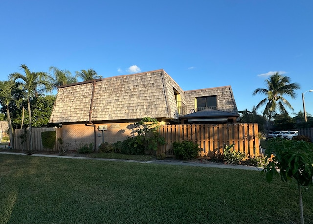 view of side of home with a yard