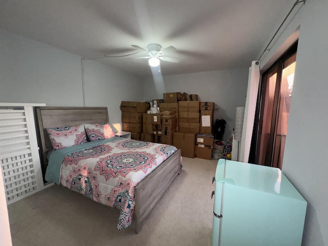 carpeted bedroom with ceiling fan and refrigerator