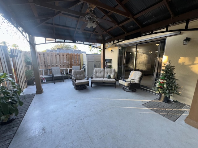 view of patio with an outdoor living space, a gazebo, and a storage shed