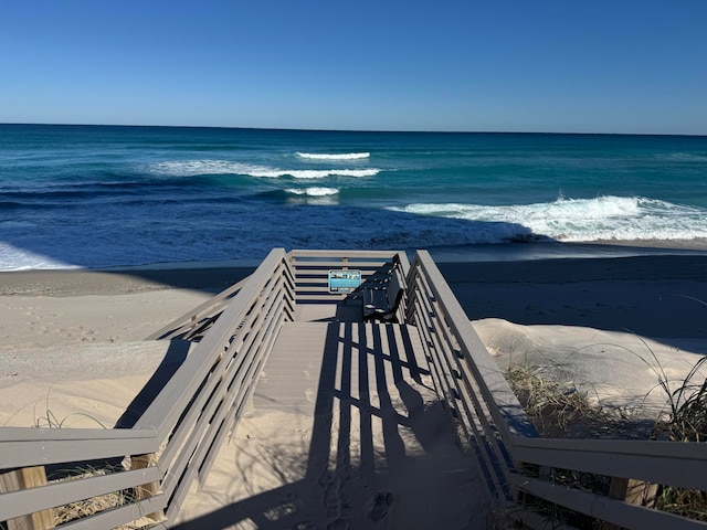 view of home's community featuring a beach view and a water view