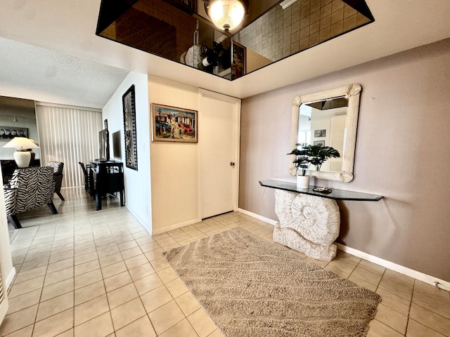 entrance foyer featuring a textured ceiling and light tile patterned flooring