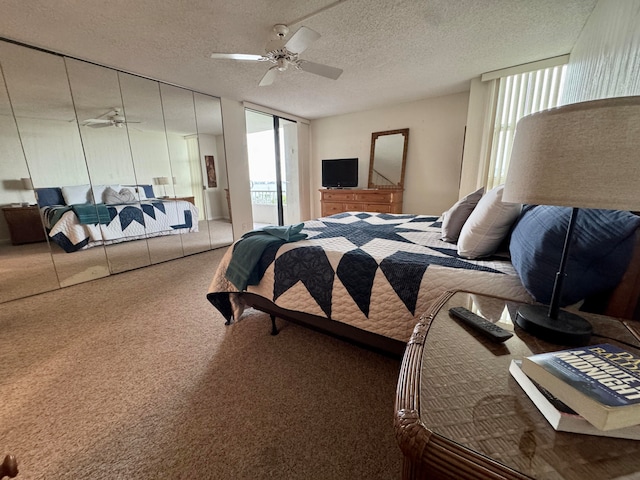 bedroom with carpet, ceiling fan, and a textured ceiling