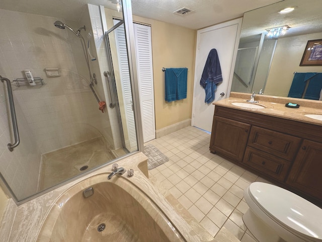 full bathroom with vanity, plus walk in shower, tile patterned flooring, toilet, and a textured ceiling