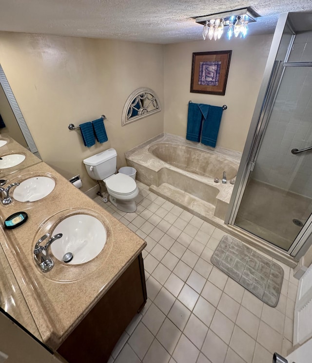 full bathroom with a textured ceiling, vanity, independent shower and bath, tile patterned flooring, and toilet