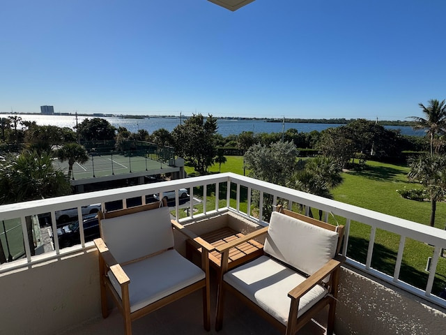 balcony featuring a water view