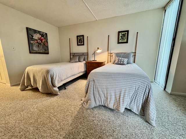 bedroom with carpet floors and a textured ceiling