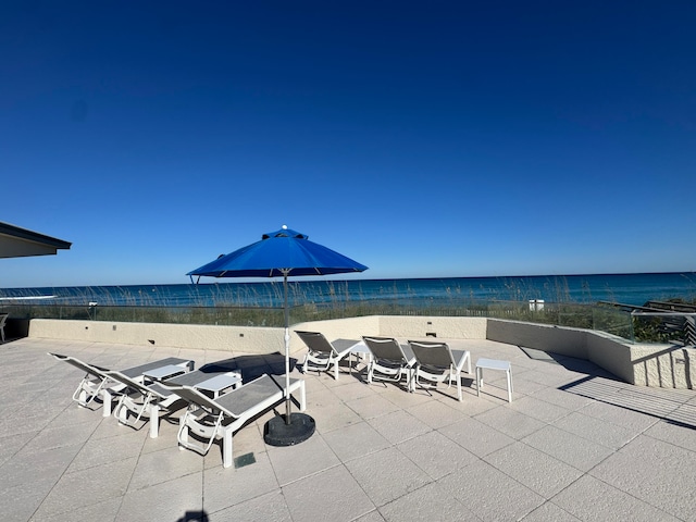 view of patio with a view of the beach and a water view