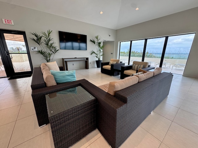 tiled living room with plenty of natural light and lofted ceiling