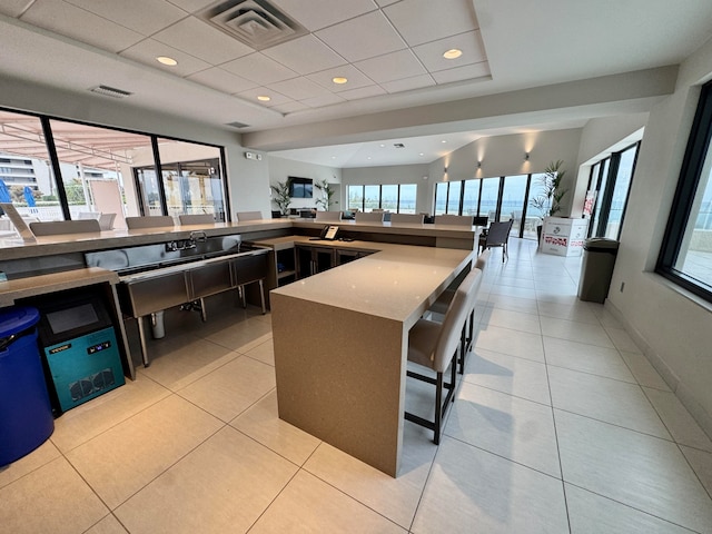 kitchen with a breakfast bar and light tile patterned floors