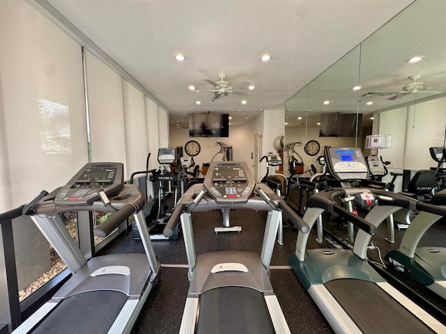 gym with ceiling fan and a textured ceiling