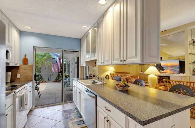 kitchen featuring a textured ceiling, sink, white cabinets, and white appliances