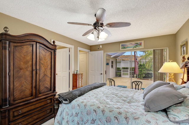 bedroom with access to outside, ceiling fan, and a textured ceiling