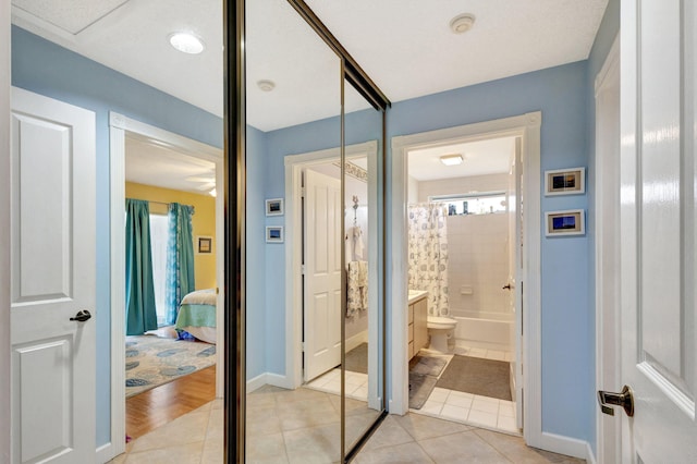 full bathroom with tile patterned flooring, toilet, plenty of natural light, and shower / tub combo with curtain