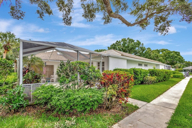 view of side of property featuring a lanai