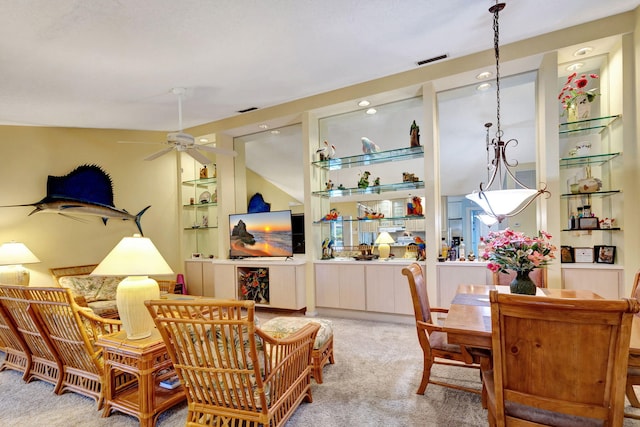 interior space with carpet, ceiling fan, and lofted ceiling