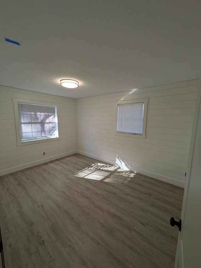 unfurnished room with hardwood / wood-style floors