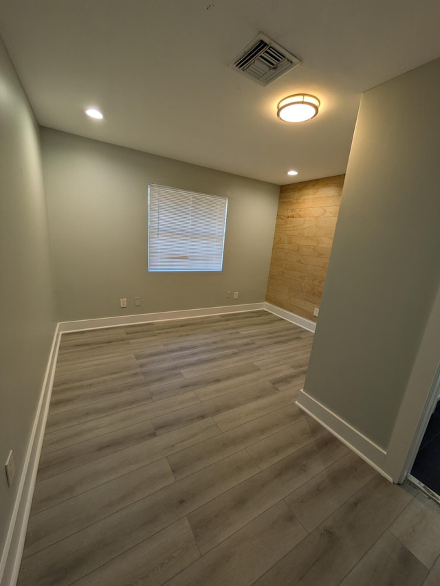 empty room with hardwood / wood-style floors