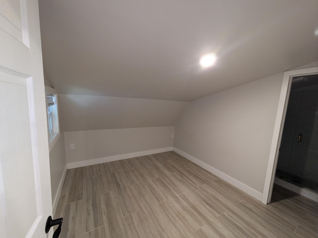 bonus room featuring light hardwood / wood-style floors and lofted ceiling