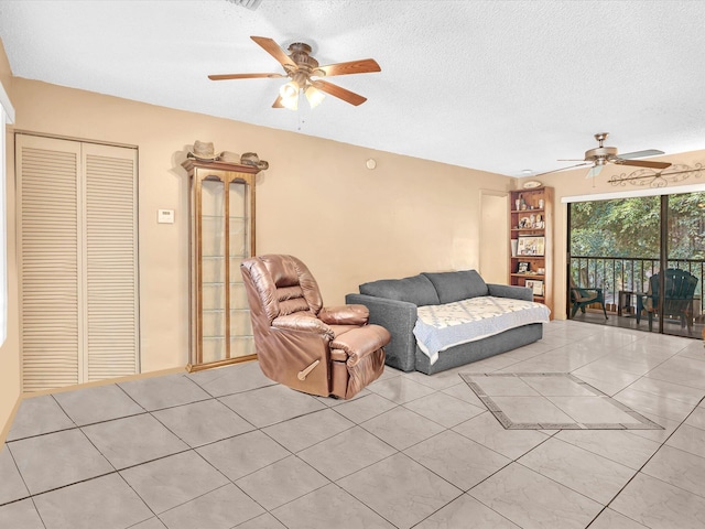 tiled living room featuring a textured ceiling, built in features, and ceiling fan