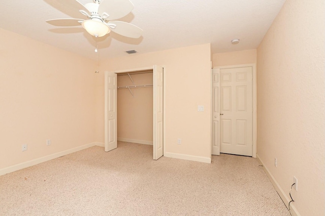 unfurnished bedroom with ceiling fan and a closet