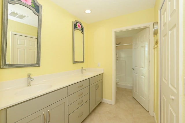 bathroom with walk in shower, tile patterned flooring, vanity, and toilet