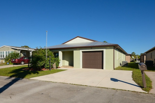 view of front of property featuring central AC unit and a garage