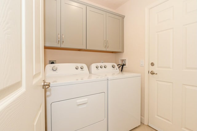 laundry room with cabinets and washer and dryer