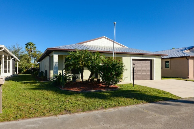 view of front of home with a front yard and a garage