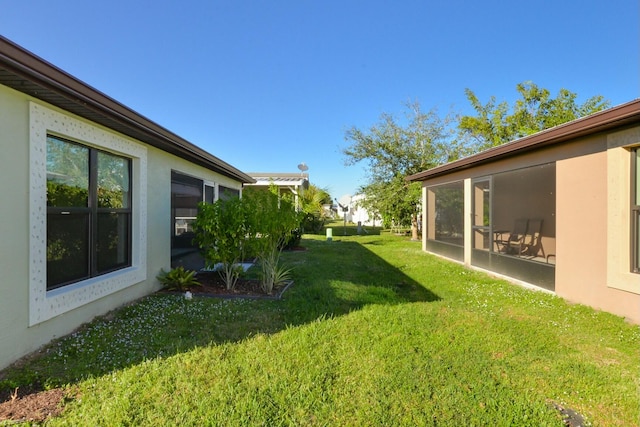 view of yard featuring a sunroom