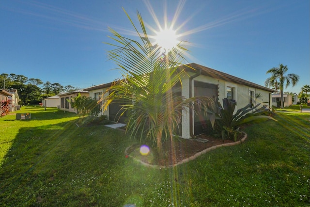 view of side of home with a yard