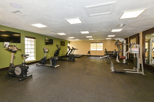 exercise room with a textured ceiling