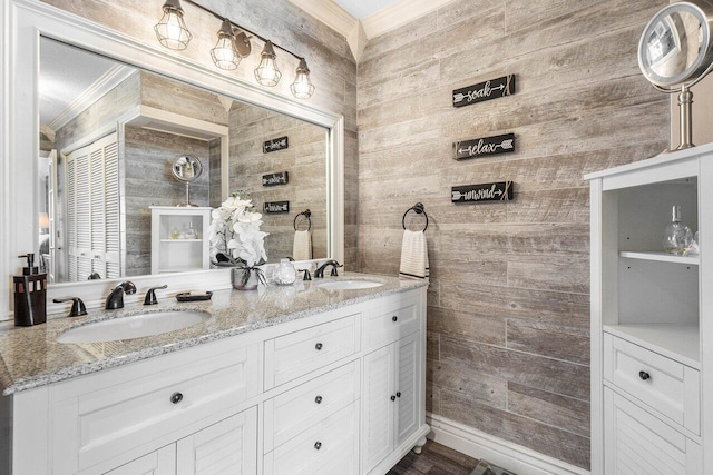 bathroom featuring vanity, crown molding, and wooden walls