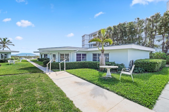 ranch-style house with a front lawn